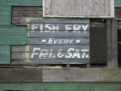 New Orleans: Weathered old sign on side of building Uptown, advertising "Fish Fry" held every Friday and Saturday