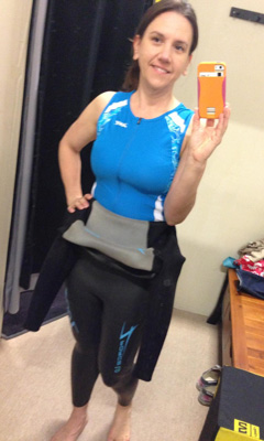 Heather trying on wetsuite for triathlon